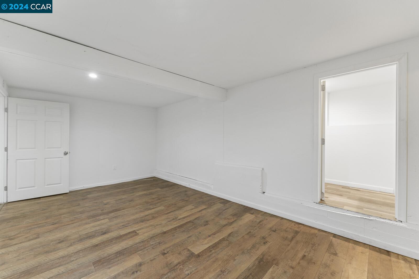 Undisclosed Address Richmond, CA 94805 - Photo 35 of 47 a view of an empty room with wooden floor and a window