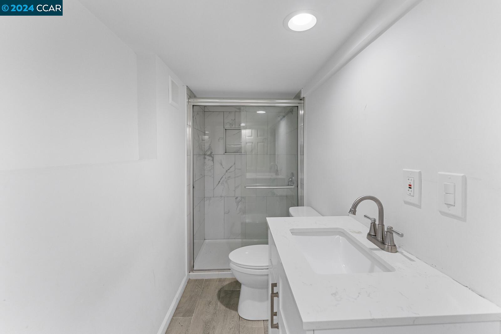 Undisclosed Address Richmond, CA 94805 - Photo 37 of 47 a bathroom with a sink toilet and a mirror