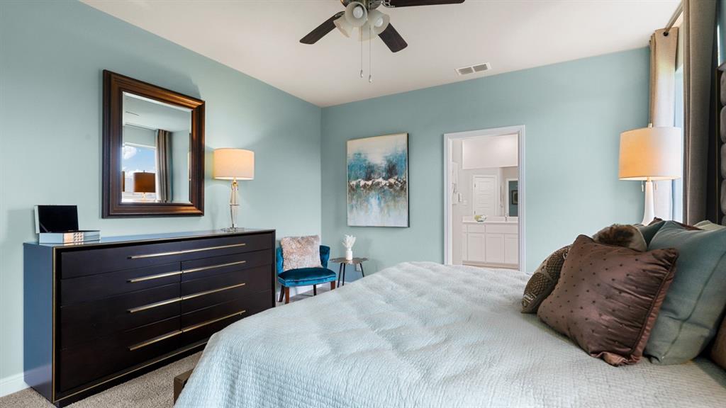 110 Stanton Avenue Rhome, TX 76078 - Photo 17 of 39 a bedroom with a bed and a chandelier