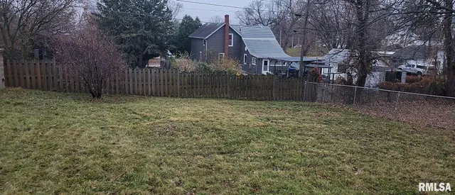 a view of outdoor space and wooden fence