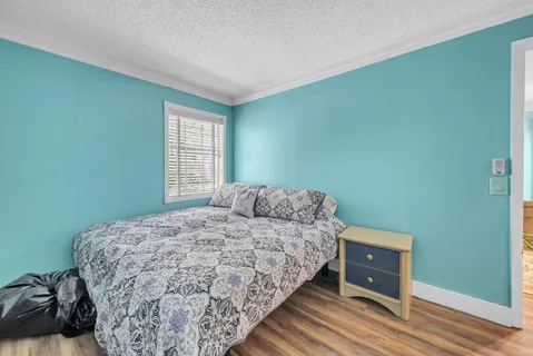 a living room with furniture a flat screen tv and a window