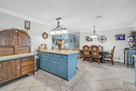 a view of a dining room with furniture and chandelier
