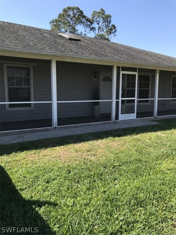 9104 Temple Road West Fort Myers, FL 33967 - Photo 1 of 12 a view of a house with a large window and wooden fence