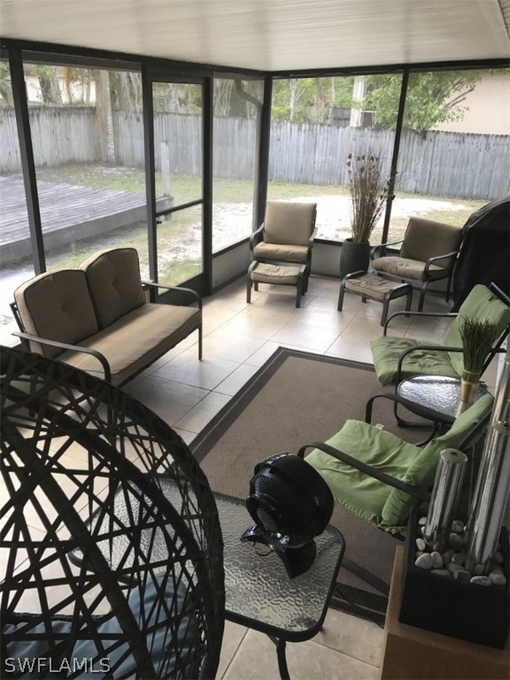 9104 Temple Road West Fort Myers, FL 33967 - Photo 12 of 12 a living room with furniture and a floor to ceiling window