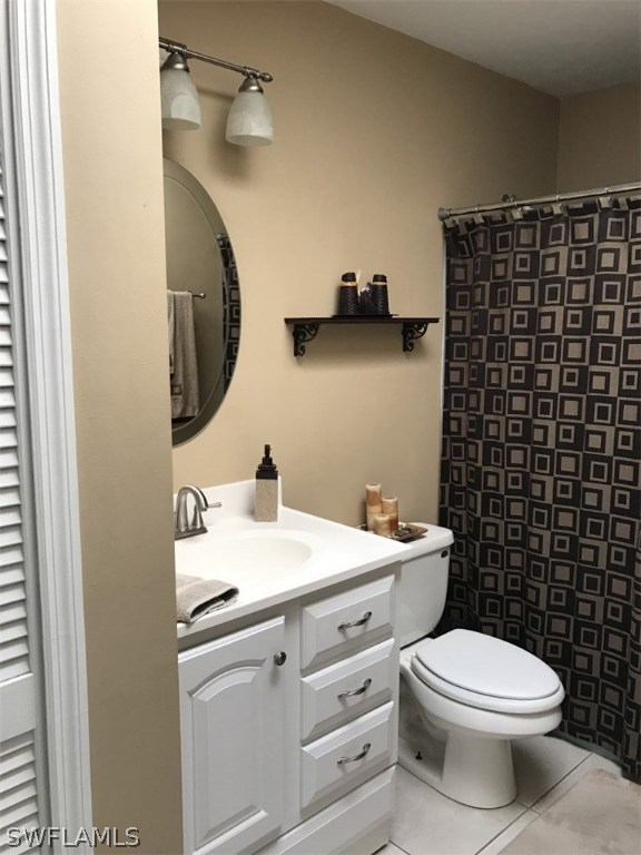 9104 Temple Road West Fort Myers, FL 33967 - Photo 7 of 12 a bathroom with a toilet a sink and mirror