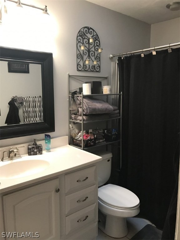 9104 Temple Road West Fort Myers, FL 33967 - Photo 10 of 12 a bathroom with a sink vanity mirror and toilet