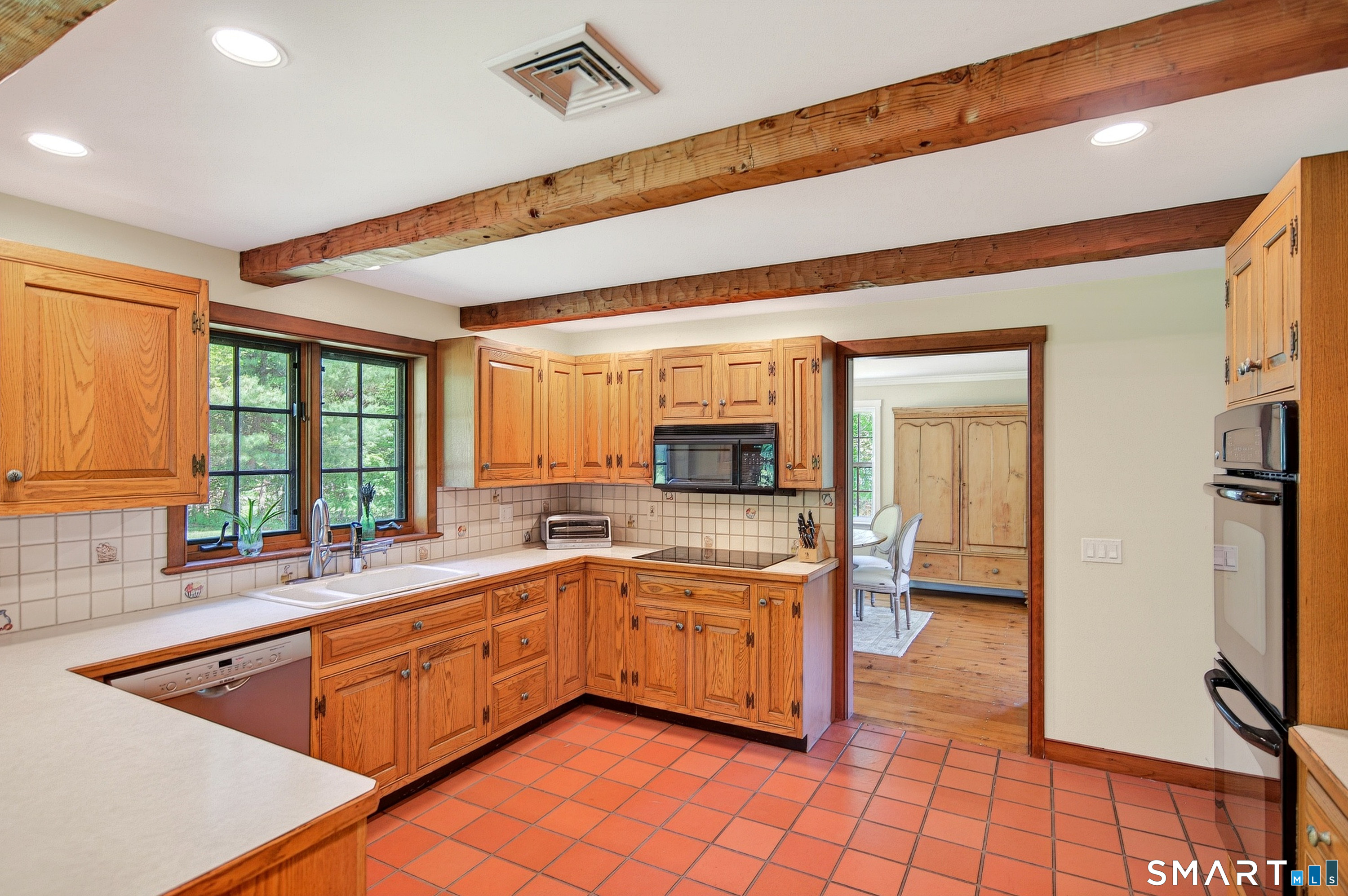 174 Huntingtown Road Newtown, CT 06470 - Photo 11 of 40 a kitchen with a sink and a stove top oven