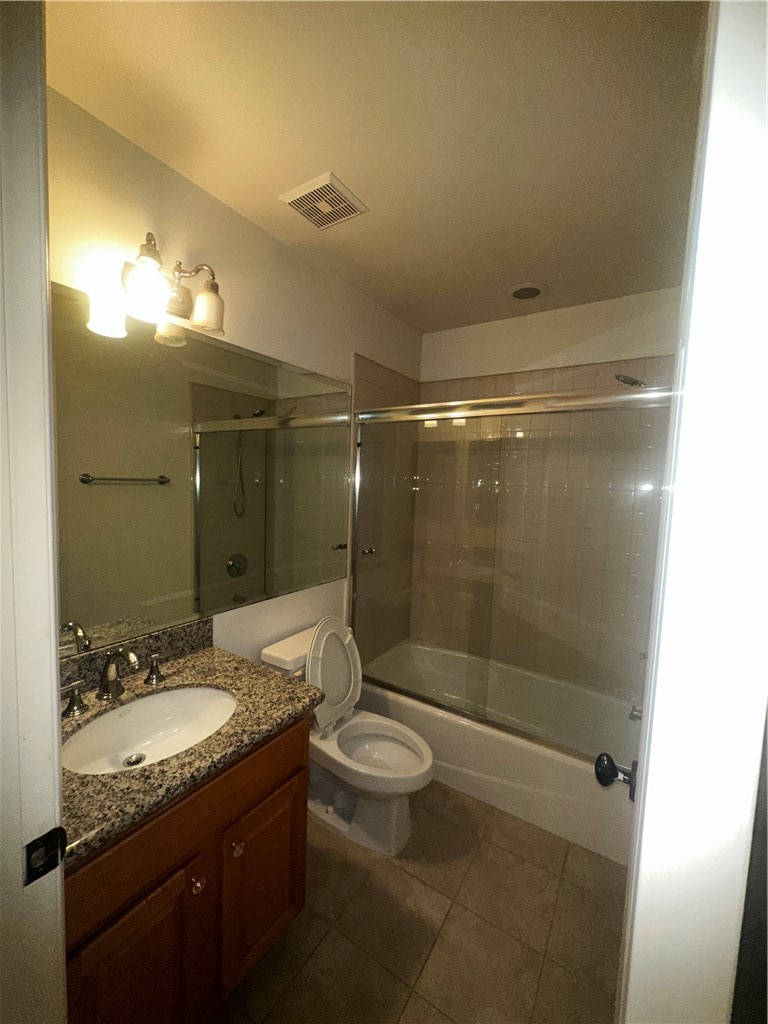 9356 19th Street, Unit D Rancho Cucamonga, CA 91701 - Photo 12 of 16 a bathroom with a granite countertop sink toilet mirror and shower