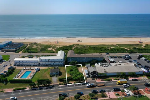 a view of swimming pool with outdoor seating and a yard