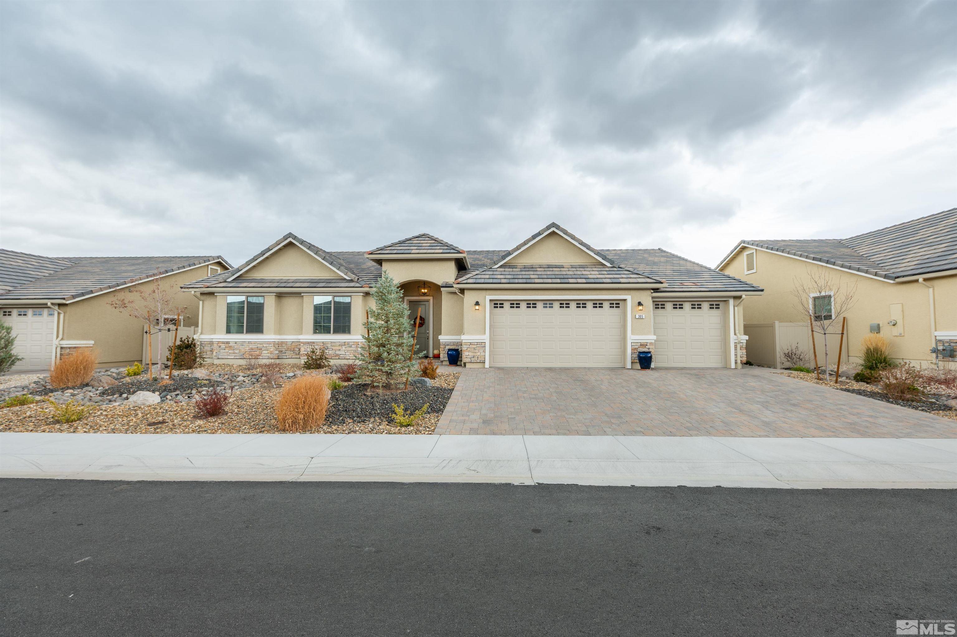 305 Desert Lily Court Reno, NV 89521 - Photo 1 of 34 a view of a white house with a yard and wooden fence