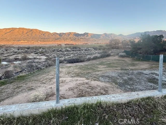 a view of a mountain with a yard