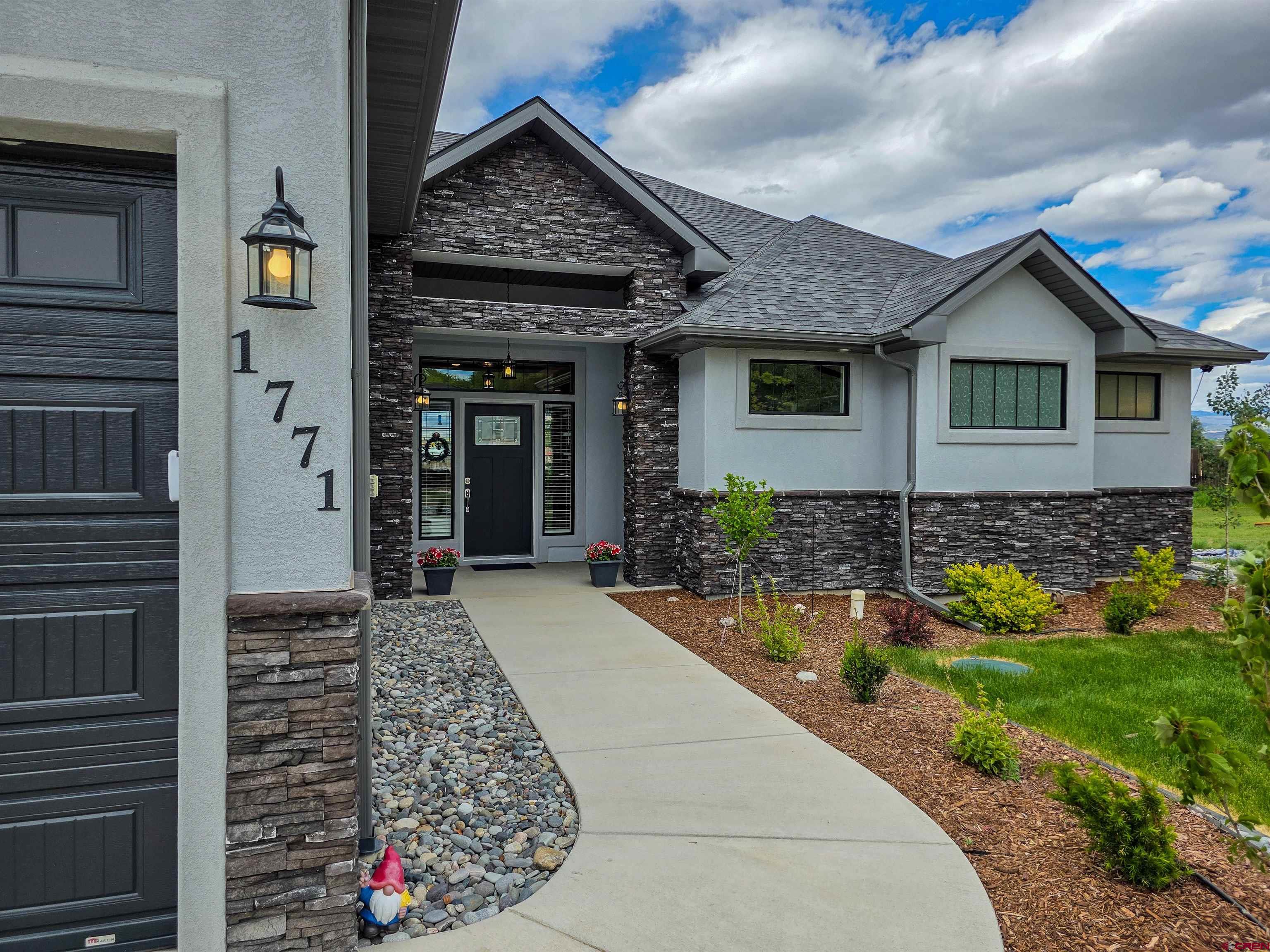 1771 Trappers Court Delta, CO 81416 - Photo 1 of 44 a front view of a house with garden