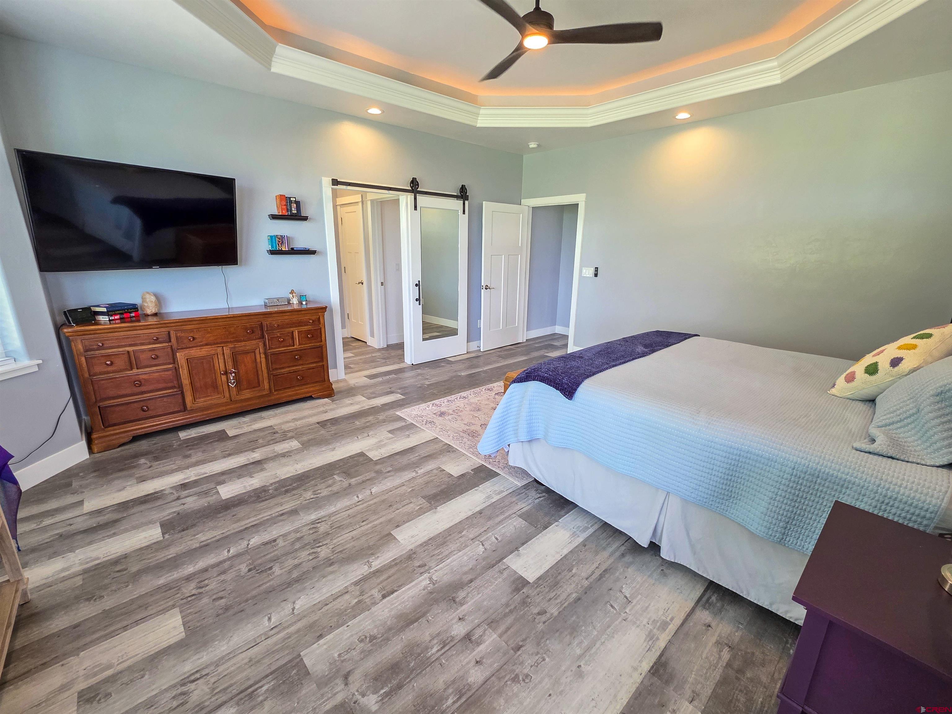 1771 Trappers Court Delta, CO 81416 - Photo 12 of 44 a bedroom with a bed and a flat screen tv