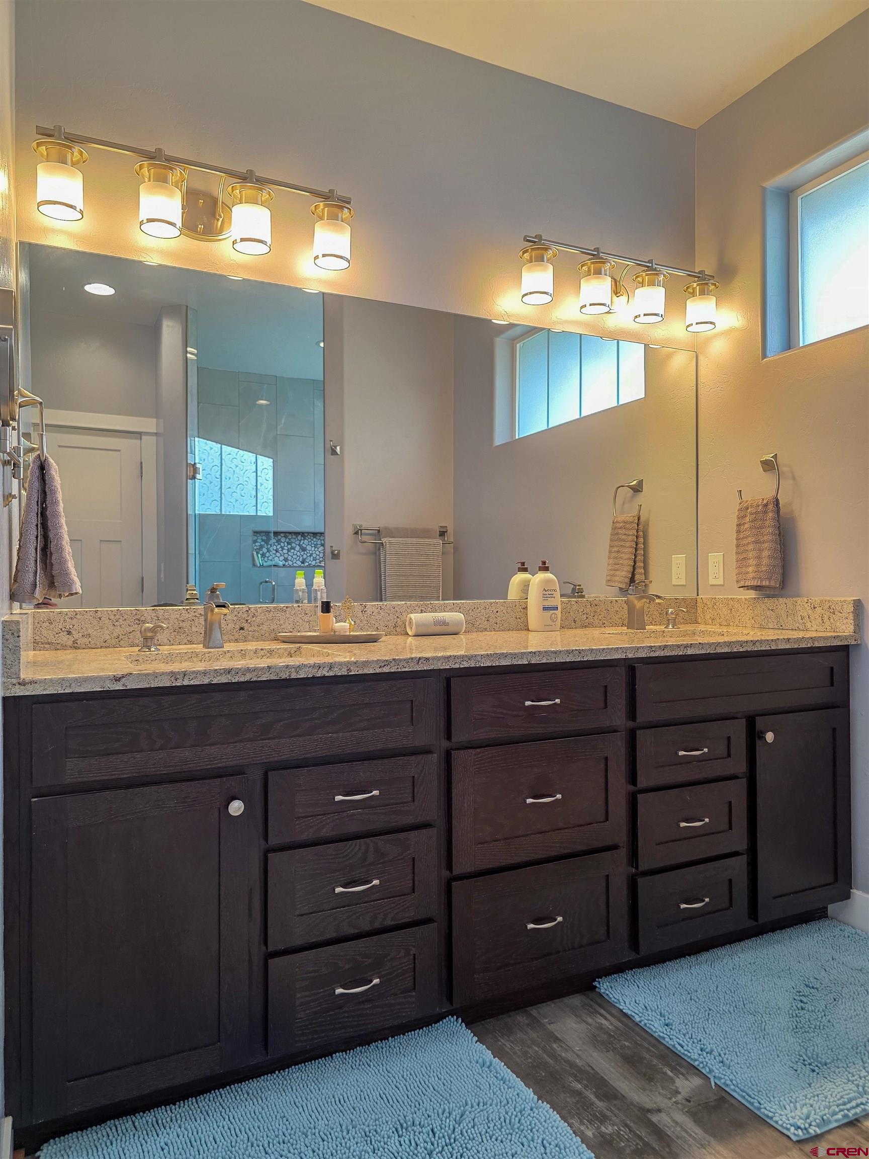 1771 Trappers Court Delta, CO 81416 - Photo 13 of 44 a bathroom with a granite countertop double vanity sink and a mirror