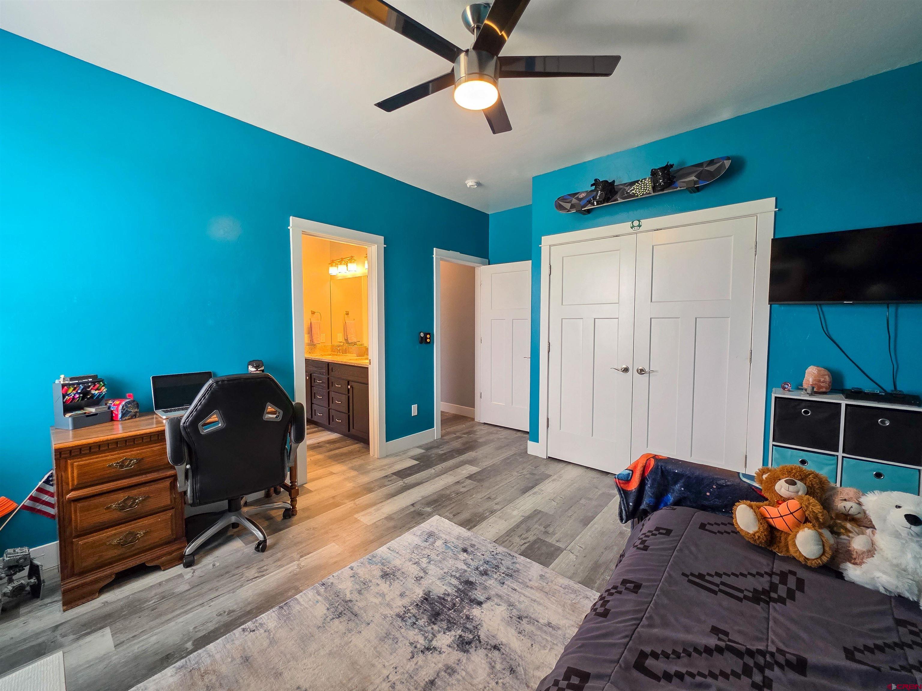 1771 Trappers Court Delta, CO 81416 - Photo 27 of 44 a bedroom with a bed and a chandelier