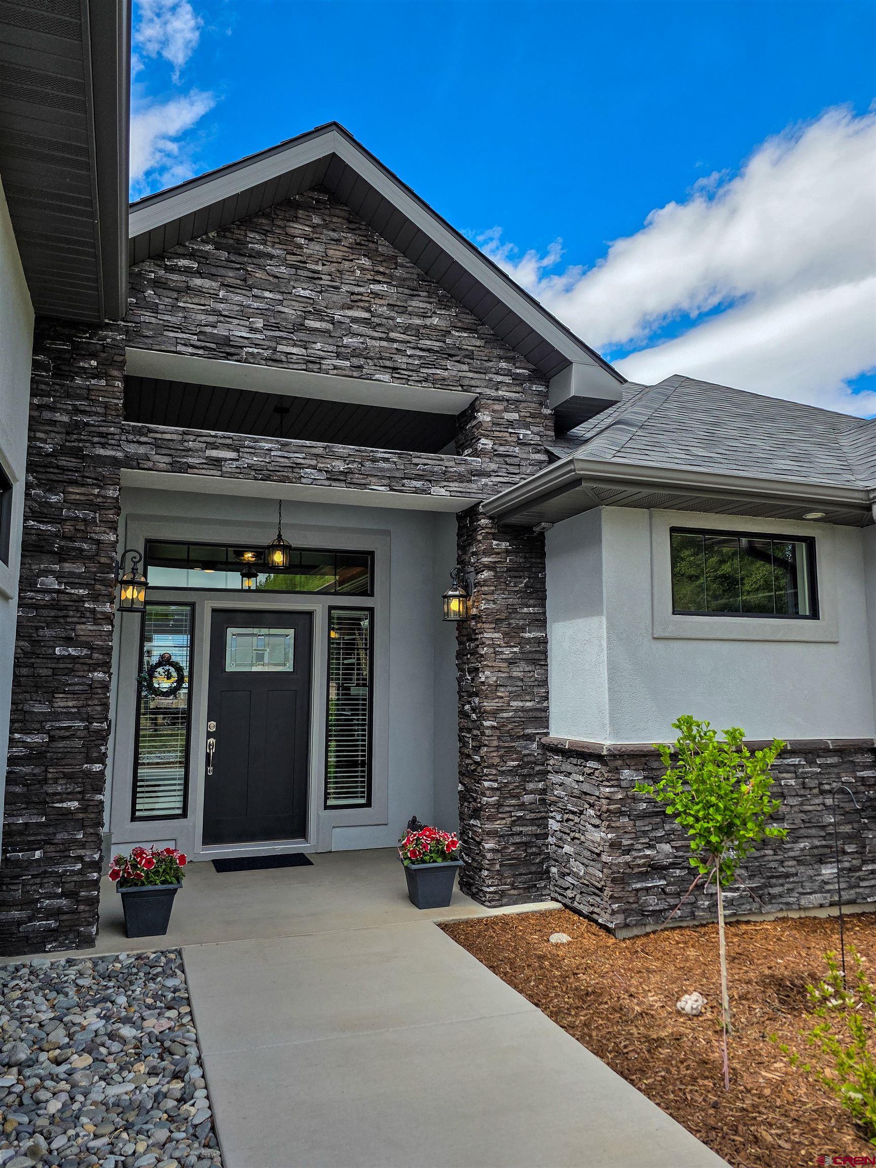 1771 Trappers Court Delta, CO 81416 - Photo 34 of 44 a view of a brick house with potted plants