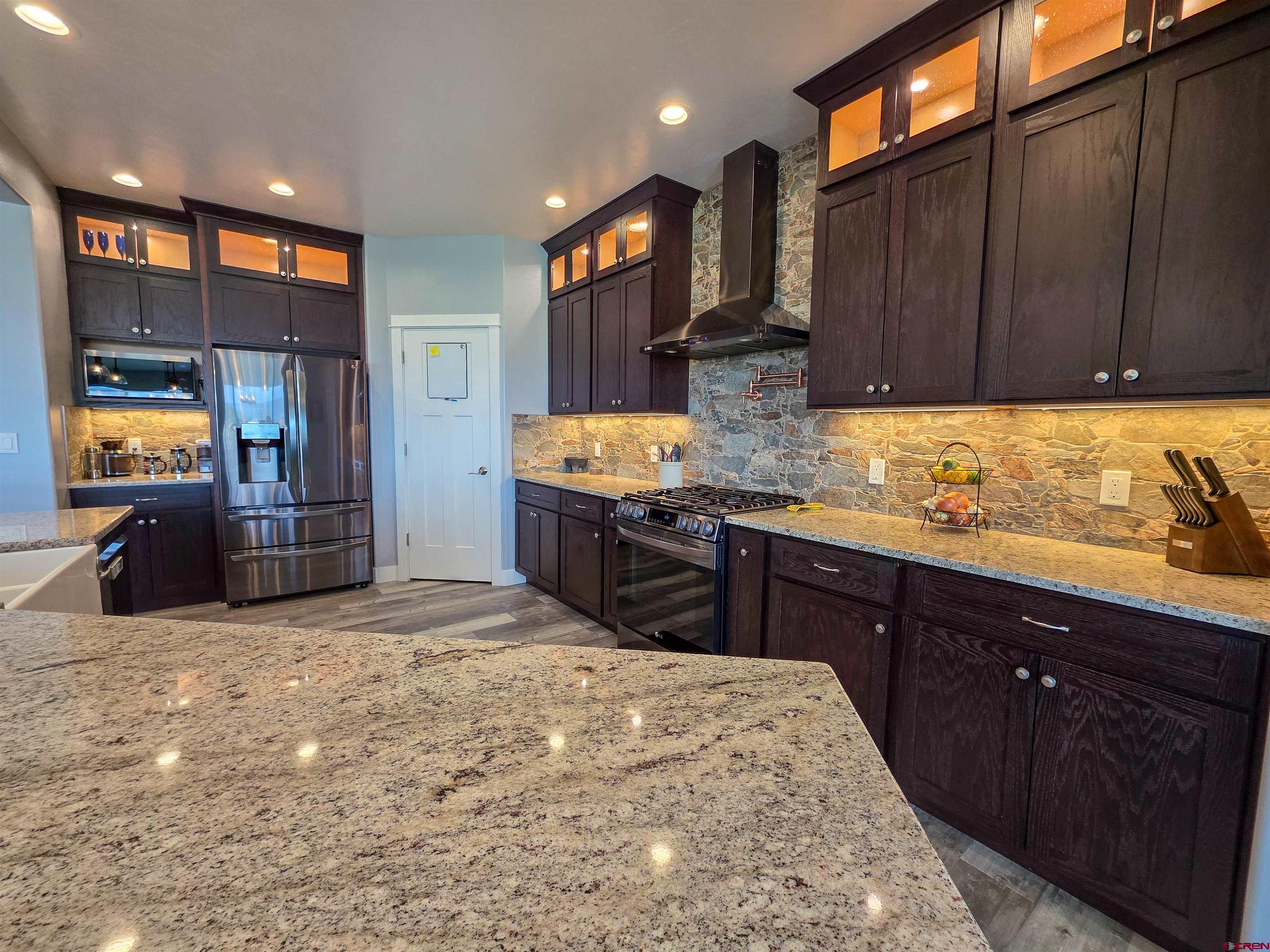1771 Trappers Court Delta, CO 81416 - Photo 6 of 44 a kitchen with stainless steel appliances granite countertop wooden cabinets a oven and granite counter tops