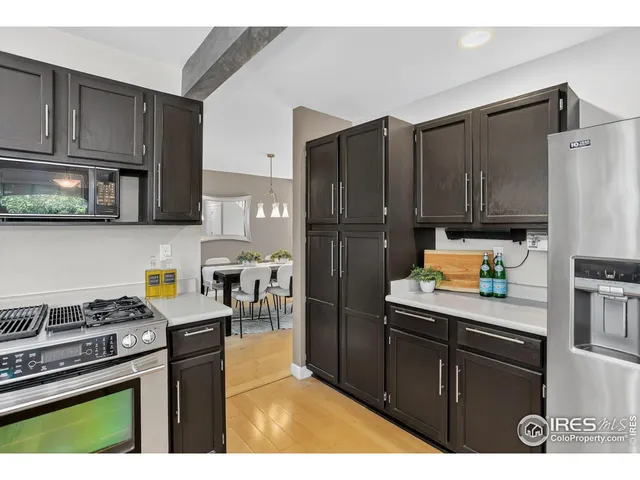 a kitchen with stainless steel appliances granite countertop a refrigerator stove and microwave
