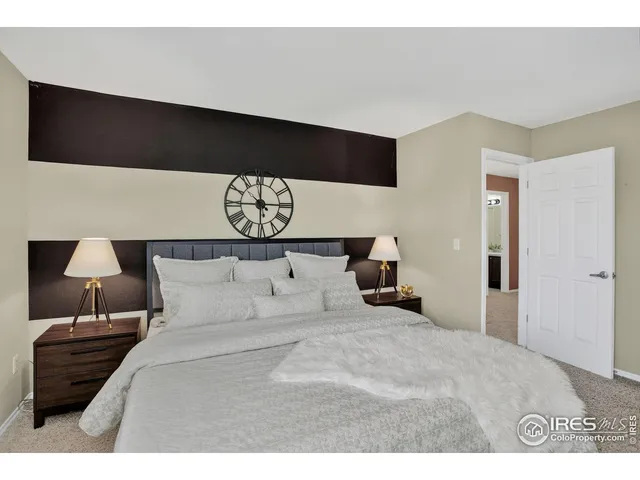 a bedroom with a bed and a night stand