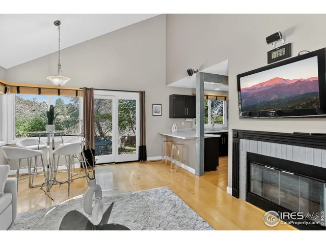 a living room with furniture a flat screen tv and a floor to ceiling window