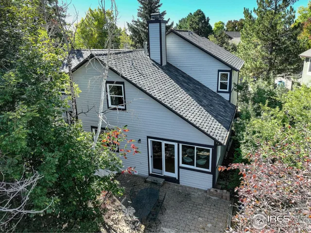 a view of a house with a yard and potted plants