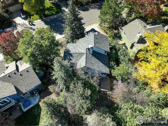 an aerial view of a house with a yard swimming pool and outdoor seating