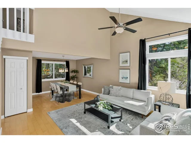 a living room with furniture and a window with garden view