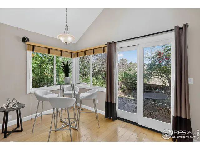a dining room with furniture window and outside view