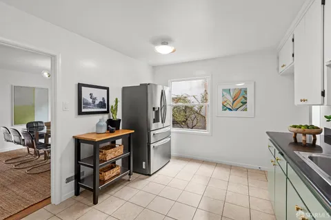 a kitchen with stainless steel appliances a refrigerator and a stove top oven