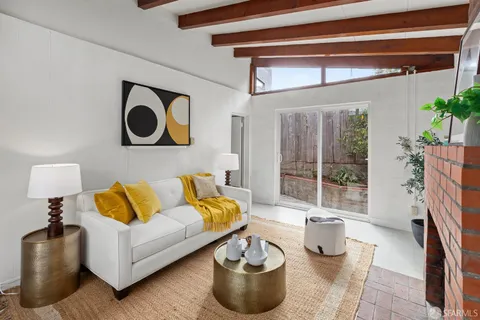 a living room with furniture and a potted plant