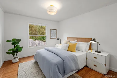 a bedroom with bed and a window