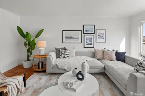 a living room with furniture and a potted plant