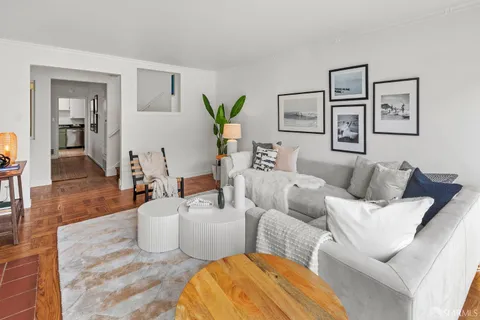 a living room with furniture and wooden floor