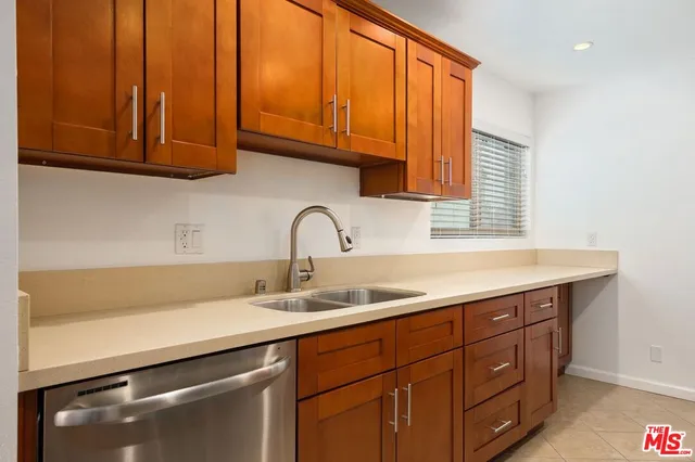a kitchen with stainless steel appliances granite countertop a sink and cabinets