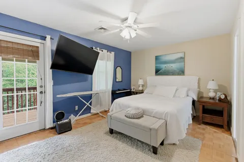 a bedroom with a bed and a flat screen tv