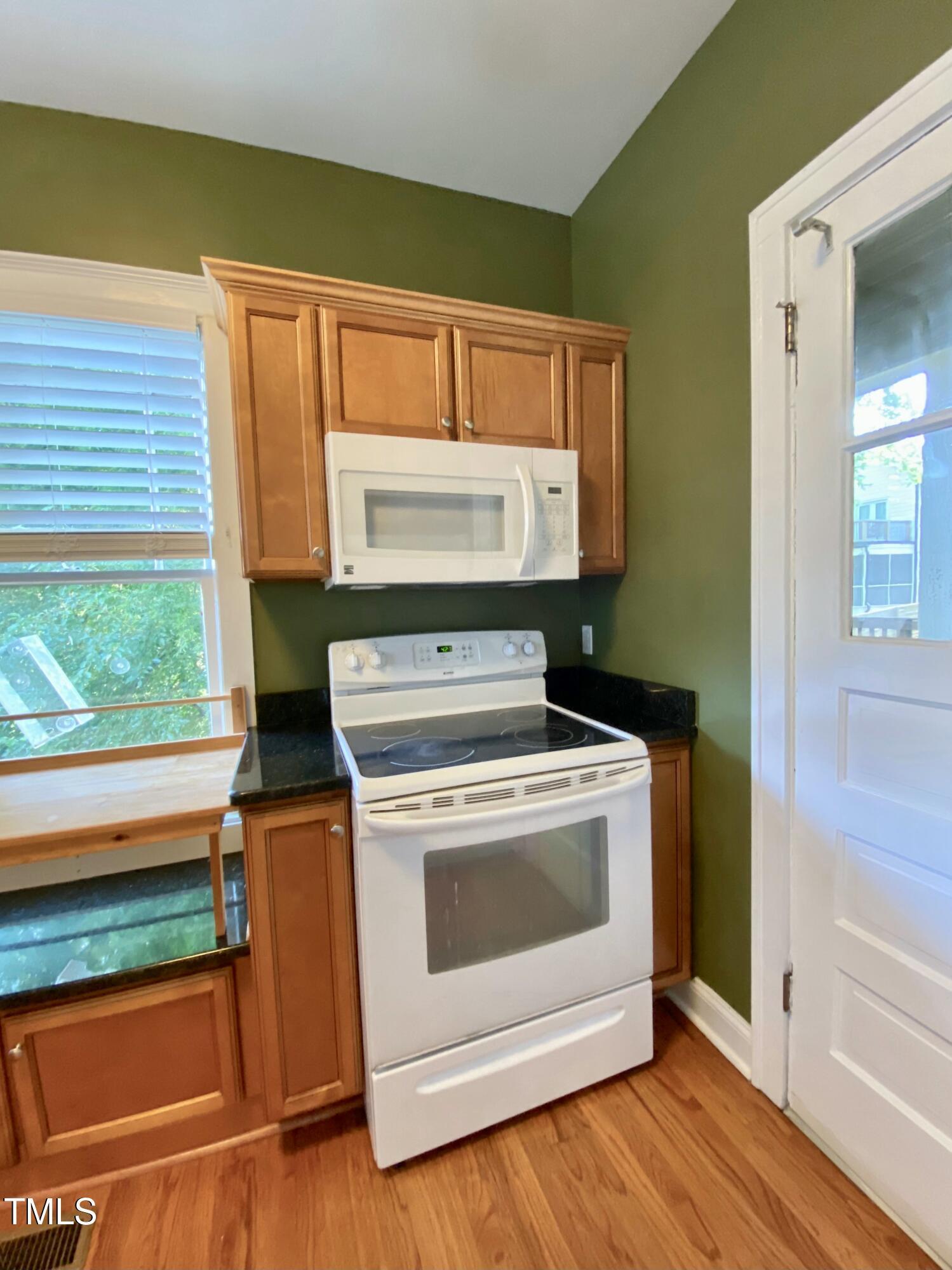 407 Ottawa Avenue Durham, NC 27701 - Photo 12 of 32 a stove top oven sitting inside of a kitchen