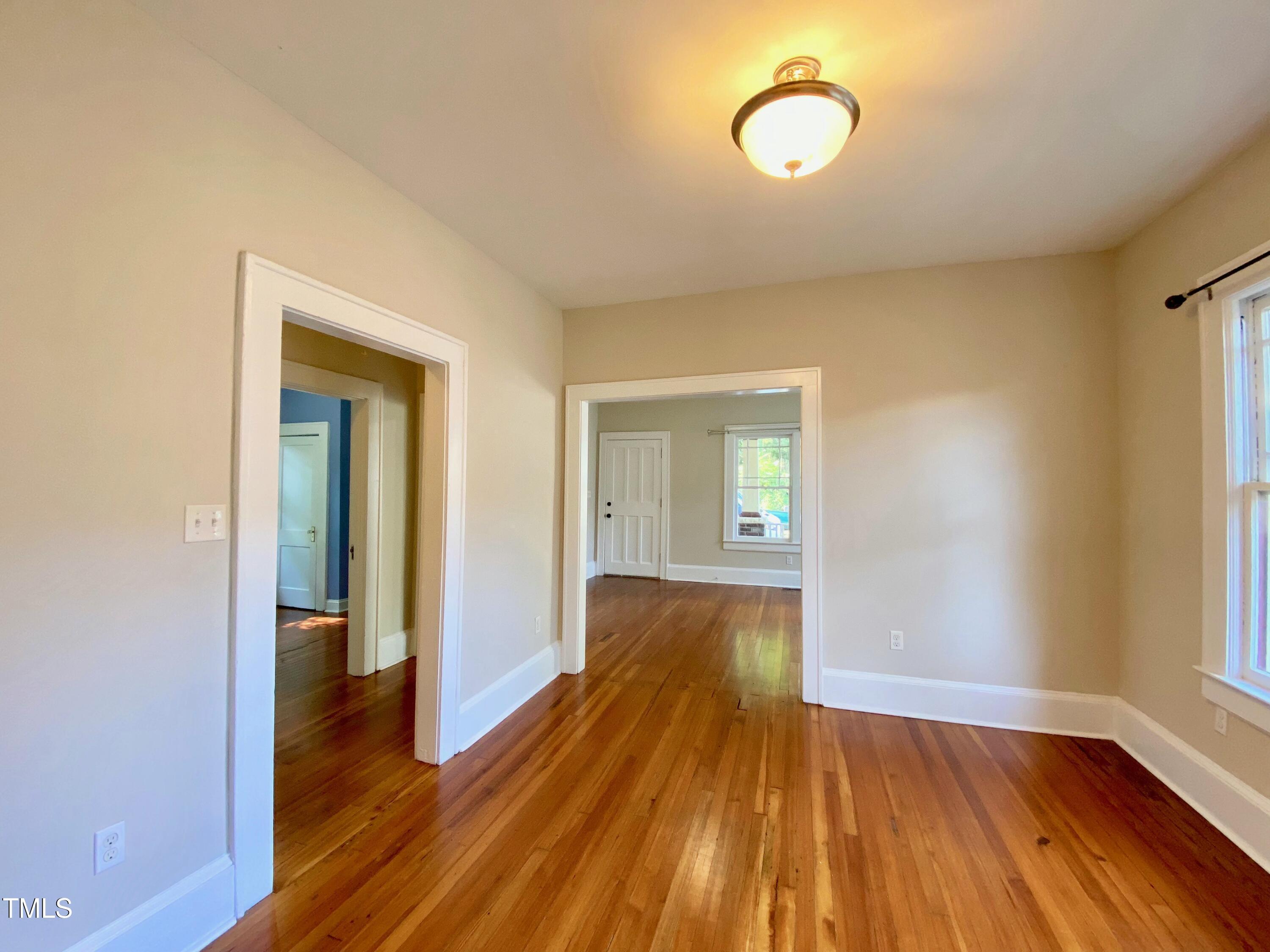 407 Ottawa Avenue Durham, NC 27701 - Photo 7 of 32 a view of a room with wooden floor and window