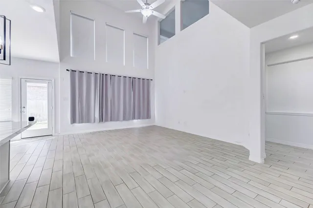 a large white kitchen with a refrigerator a stove top oven a sink and dishwasher