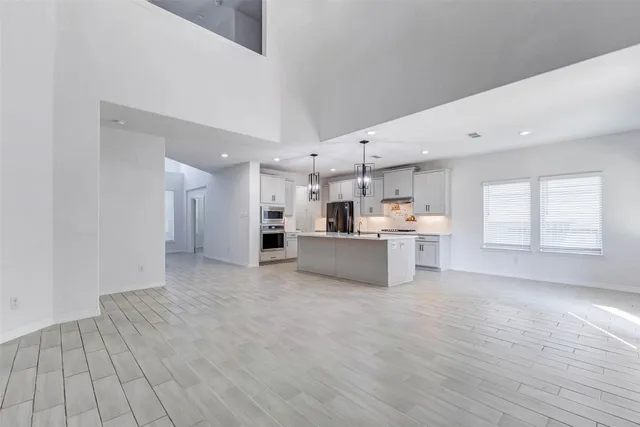 an empty room with staircase and white walls
