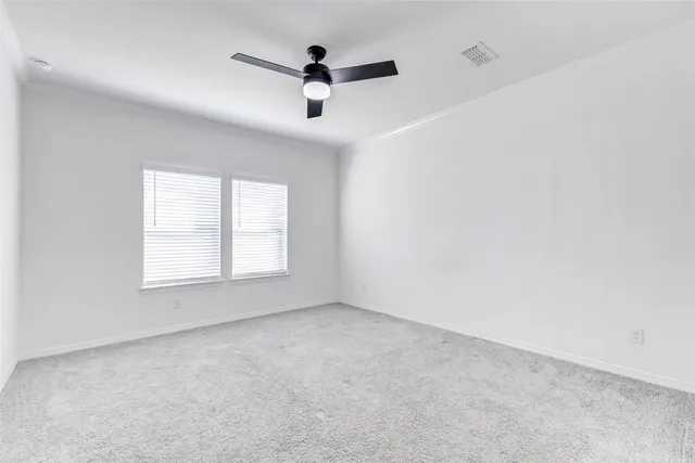 a large white kitchen with kitchen island a sink a stove a refrigerator and white cabinets