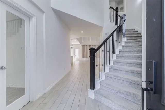 a view of a hallway with wooden floor and entryway