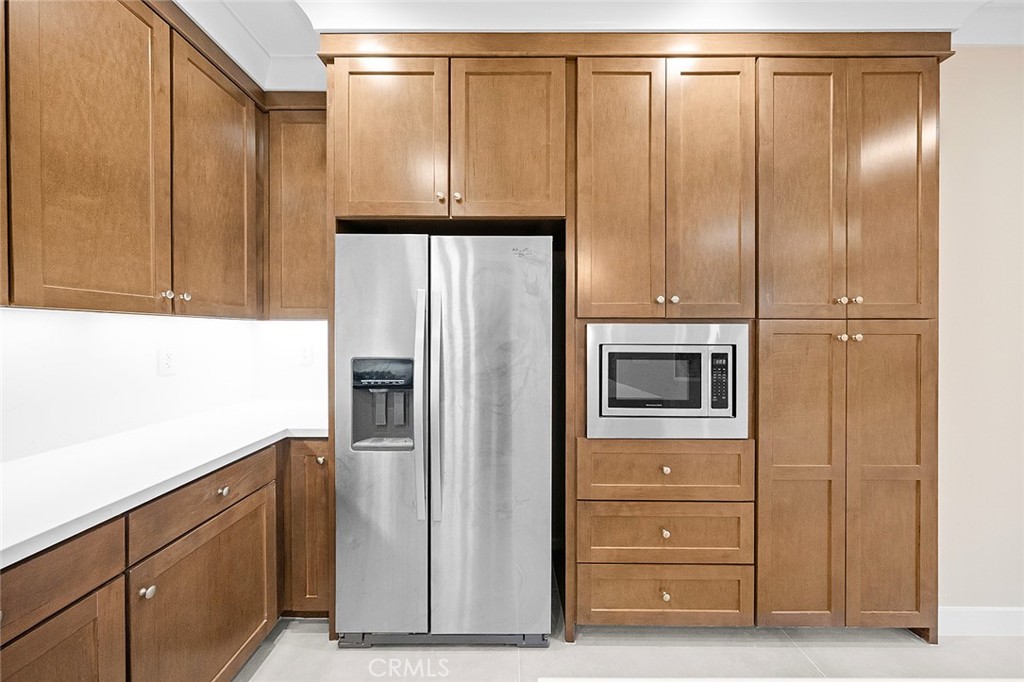 143 Rodeo Irvine, CA 92602 - Photo 6 of 37 a kitchen with a refrigerator and cabinet