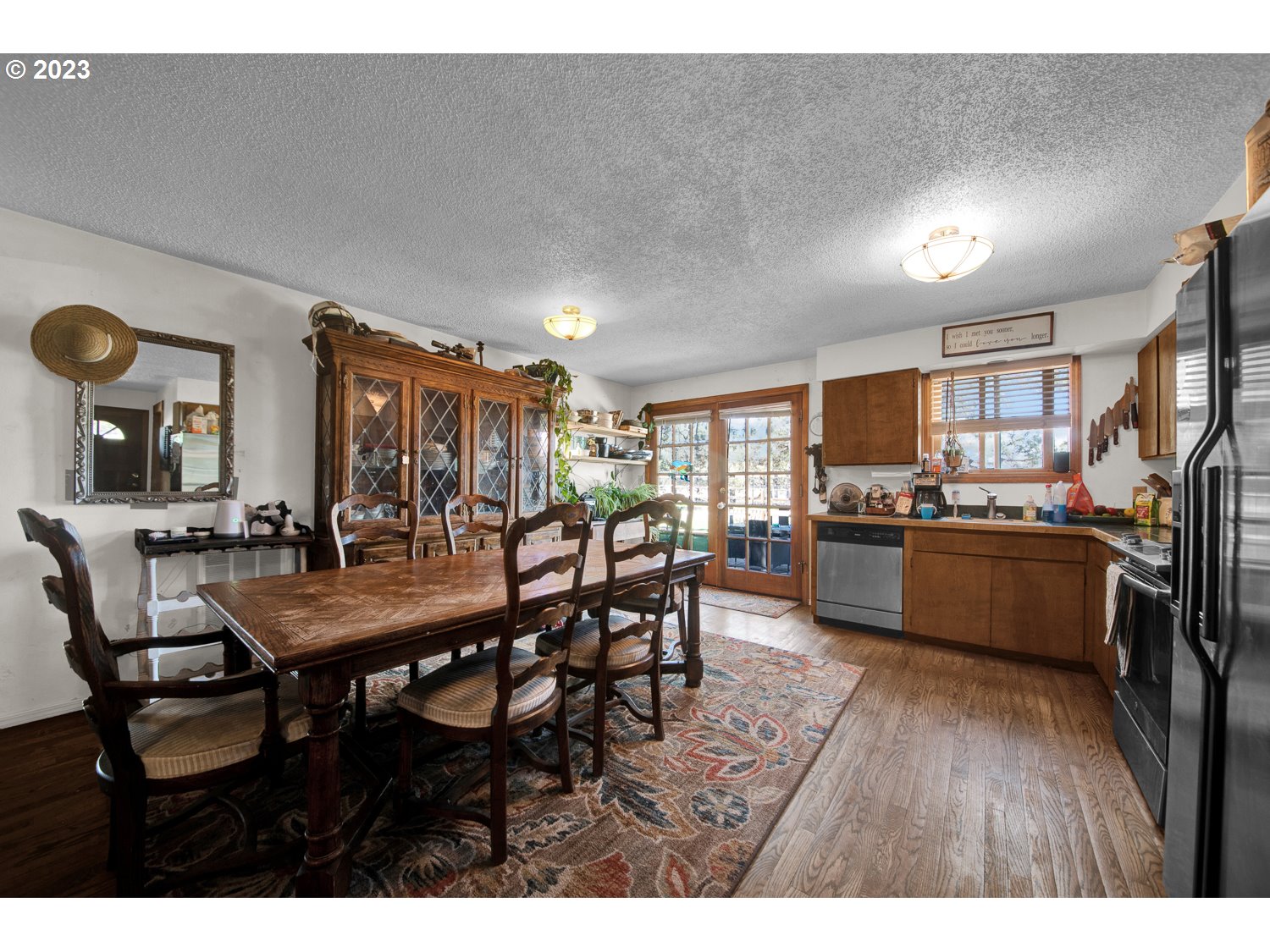 67100 Fryrear Road Bend, OR 97703 - Photo 13 of 37 a room with stainless steel appliances kitchen island granite countertop furniture and wooden floor