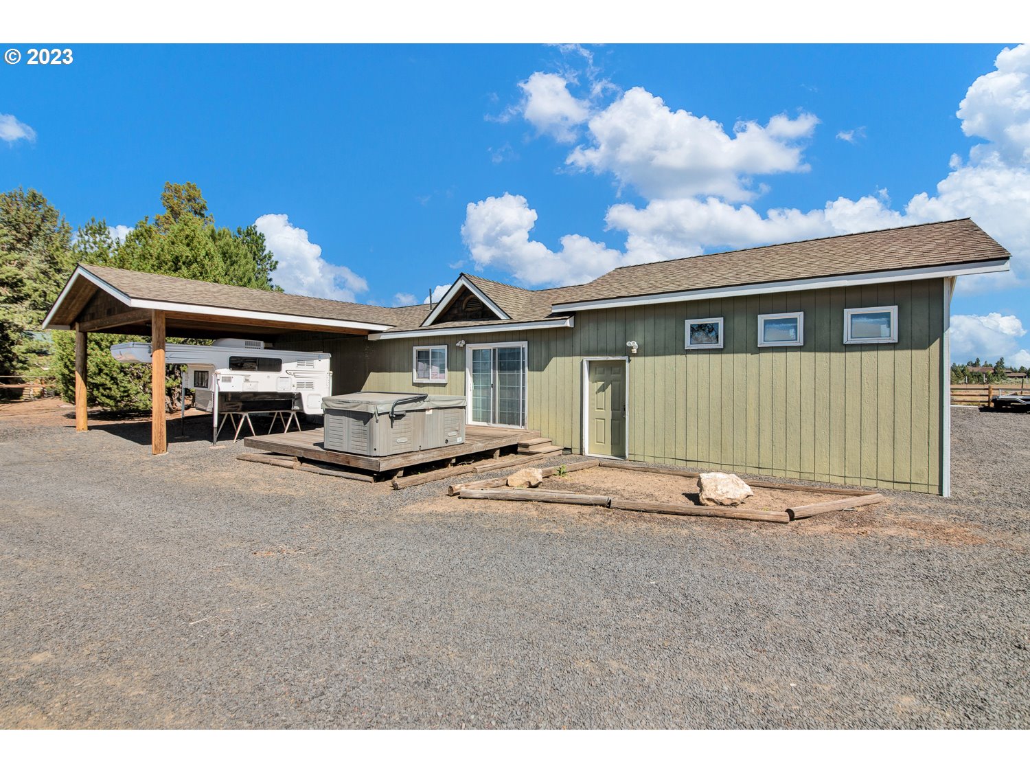67100 Fryrear Road Bend, OR 97703 - Photo 25 of 37 a front view of a house with a garden and parking