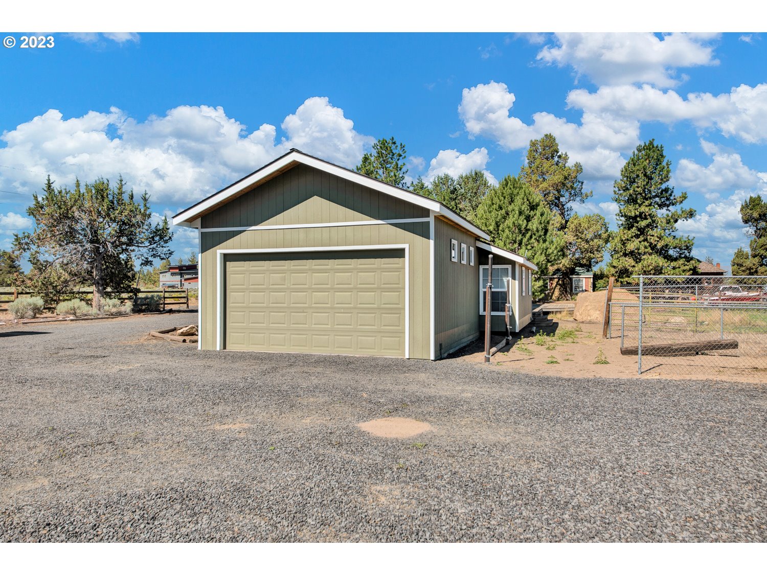 67100 Fryrear Road Bend, OR 97703 - Photo 27 of 37 a front view of a house with a yard and garage