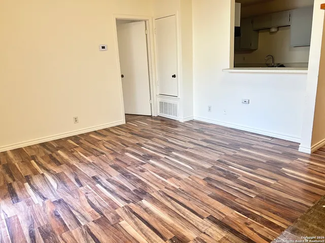 a view of a room with wooden floor and bathroom