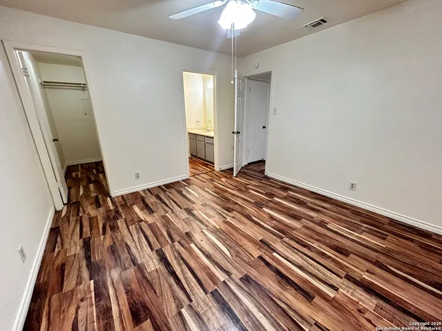 a view of a room with wooden floor and chandelier