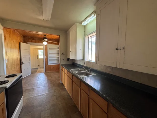 a kitchen with a sink stove and cabinets