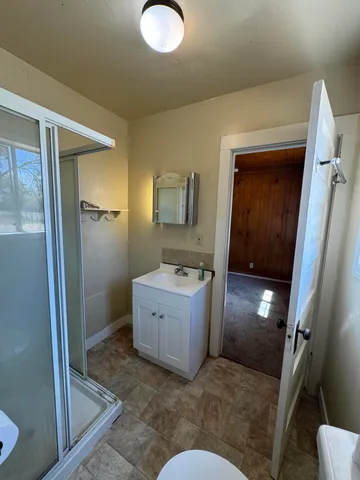 a bathroom with a tub sink and mirror