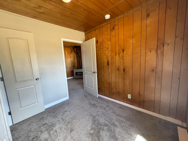 a view of empty room with a white walls